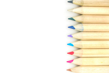 Group of mix pencil colors lay on right side on white background.