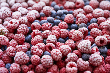 Background of frozen berries. Top view of raspberries and blueberries.