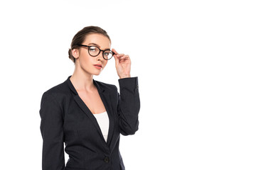 young successful businesswoman in black suit and glasses isolated on white