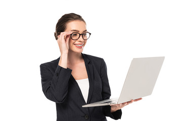 young smiling businesswoman in black suit and glasses holding laptop isolated on white