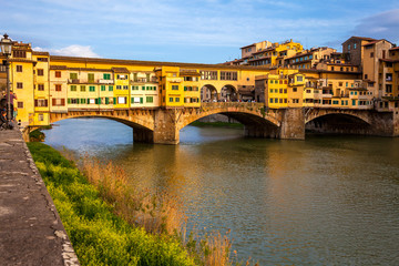 Obraz premium Golden hour at the Ponte Vecchio a medieval stone closed-spandrel segmental arch bridge over the Arno River in Florence