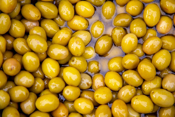 Background of green market fresh olives close up