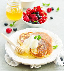 Breakfast - Cottage cheese pancakes,  curd fritters with raspberry, strawberry, blueberry.  Selective focu