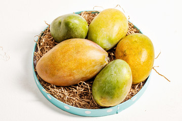 ripe fresh colorful mango on a paper Mat