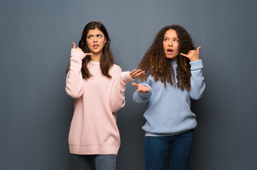 Teenager friends making phone gesture and doubting