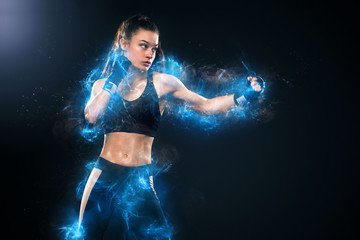 Sportsman, woman boxer fighting in gloves on black background. Boxing and fitness concept. Energy...