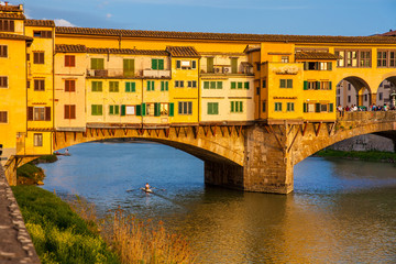 Golden hour at the Ponte Vecchio a medieval stone closed-spandrel segmental arch bridge over the Arno River in Florence