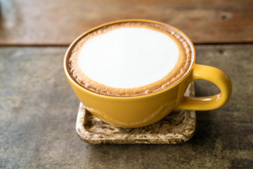 Cup of hot latte art coffee on wood table