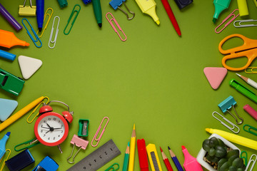 School office supplies on a desk with copy space. Back to school concept. School supplies on green background. Back 2 school concept