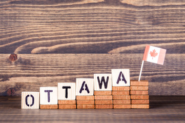 Ottawa Canada. Politics, economic and immigration concept. Wooden letters and flag on the office desk