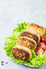 Chicken rissoles with tomato balsamic glaze, salad leaves, cherry tomatoes. Selective focus, space for text.