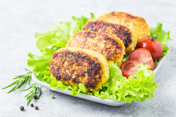 Chicken rissoles with tomato balsamic glaze, salad leaves, cherry tomatoes. Selective focus, space for text.