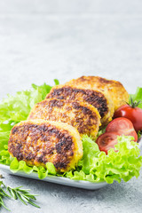 Chicken rissoles with tomato balsamic glaze, salad leaves, cherry tomatoes. Selective focus, space for text.