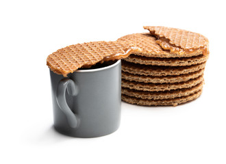 Melted Dutch caramel waffles with cup of coffee isolated on white