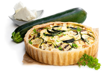 Homemade courgette and feta quiche isolated on white
