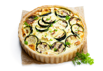 Homemade courgette and feta quiche isolated on white