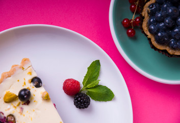 Berry cakes in the corner on a pink background. View from above. top view