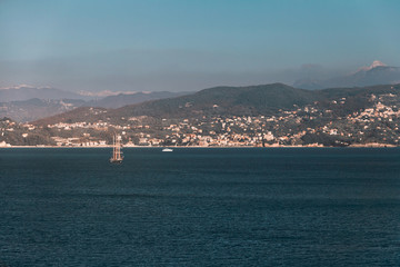 Sailing ship in the Mediterranean in the background of the Alps mountains