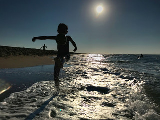 child  playing on the beach