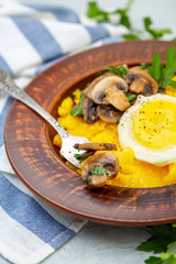 Delicious polenta with mushrooms and egg.