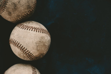 Baseball background with copy space by old used leather game ball for sport concept.