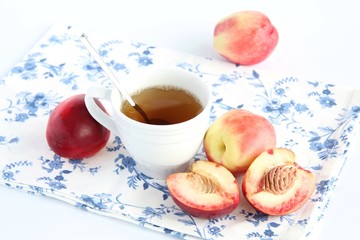 Cup of tea and peaches on the table