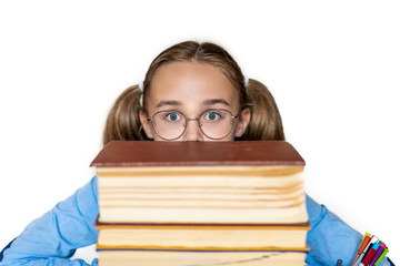 Stressed college student peeking out from behind a stack of books, tired of hard learning with books in exams tests preparation, overwhelmed high school teen girl exhausted with difficult studies