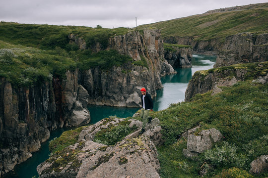 Young tourist or travel blogger, hikes on trail or path in norway or iceland, explores nomadic lifestyle in search for epic location. Generation z new lifestyle and travelling trend. Millennial goals