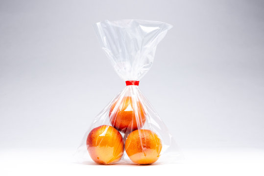 Three oranges  in a plastic bag
