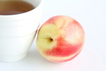 peach on a plate isolated on white
