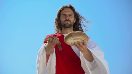Jesus showing fish and bread, biblical story, miracle about feeding thousands