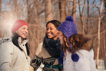Group of girl friends enjoying taking selfies in the snow in winter
