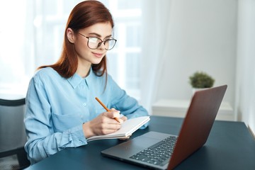 female doctor working on laptop in her office