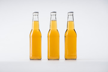 bottles of beer in row on white background