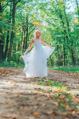 adorable child in long white wedding dress