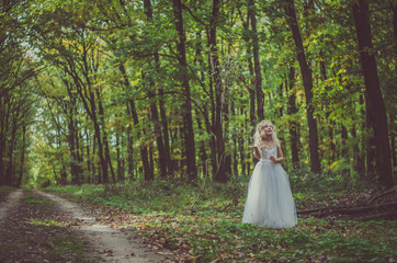 adorable child in long white wedding dress