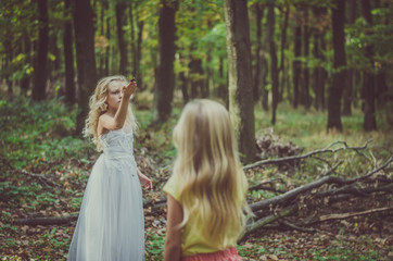adorable child in long white wedding dress with butterfly in hands