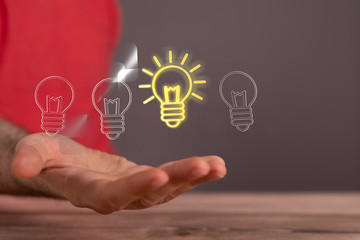  holding illuminated light bulb, idea, innovation and inspiration concept.