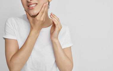 young woman applying cream on her face