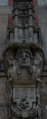 Plaster cast of the face on the facade of the house