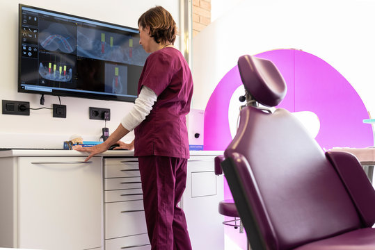 Dentist checking on screen an odontology software in dental clinic.