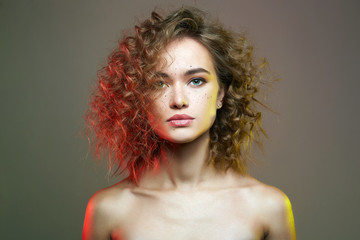 Beautiful woman in colorful Lights. amazing curly girl