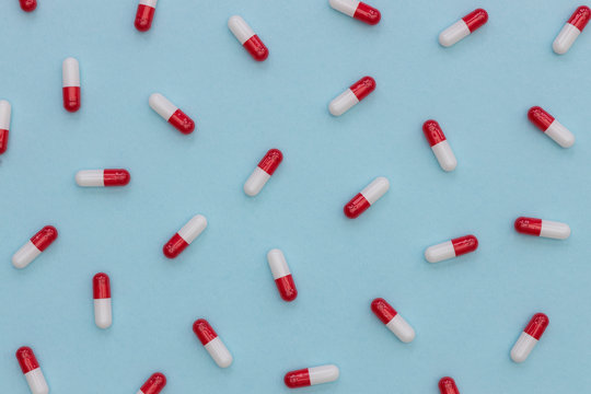 Drugs pills capsules on blue background abstract minimal concept