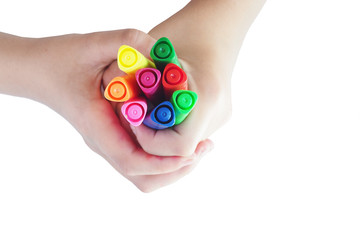 Children's hands hold colored felt-tip pens. Isolate on white background..