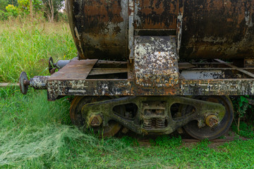 Fototapeta na wymiar Rusty wheels of old and abandoned wagon train