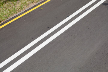 Obraz premium Asphalt road with yellow and white lines background