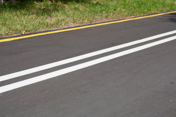 Fototapeta na wymiar Asphalt road with yellow and white lines background