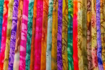 A full frame photograph of a display of colourful material