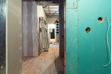 Working process of installing  frames for plasterboard - drywall and construction tools in...