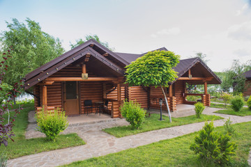 Country cottages with log and timber in the green area. cozy eco-friendly houses made of natural wood, bungalows for families